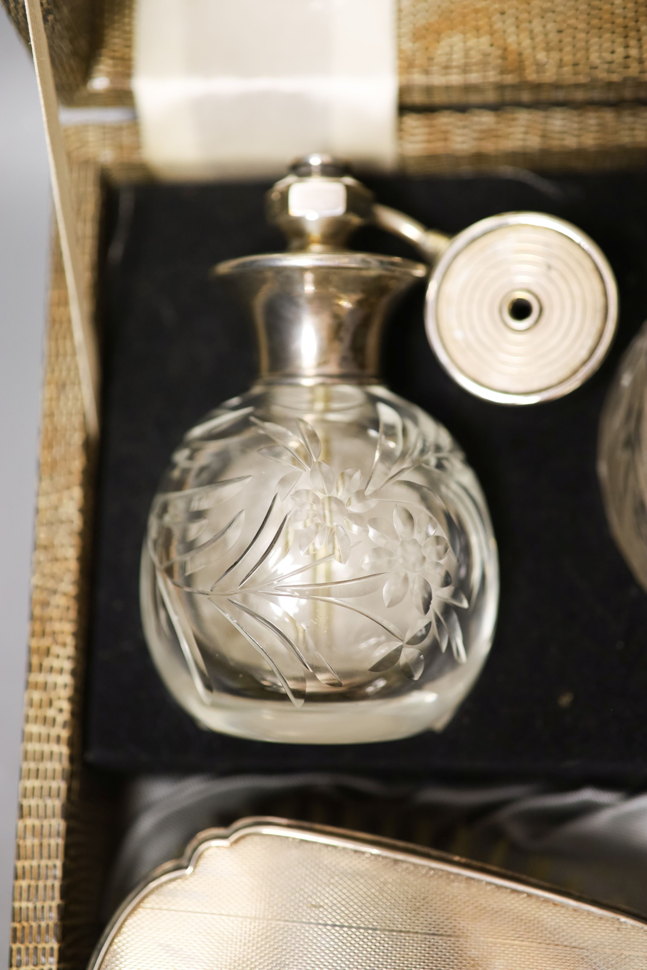 A late 1940's cased silver mounted eight piece dressing table set with atomiser, scent bottle and powder bowl.